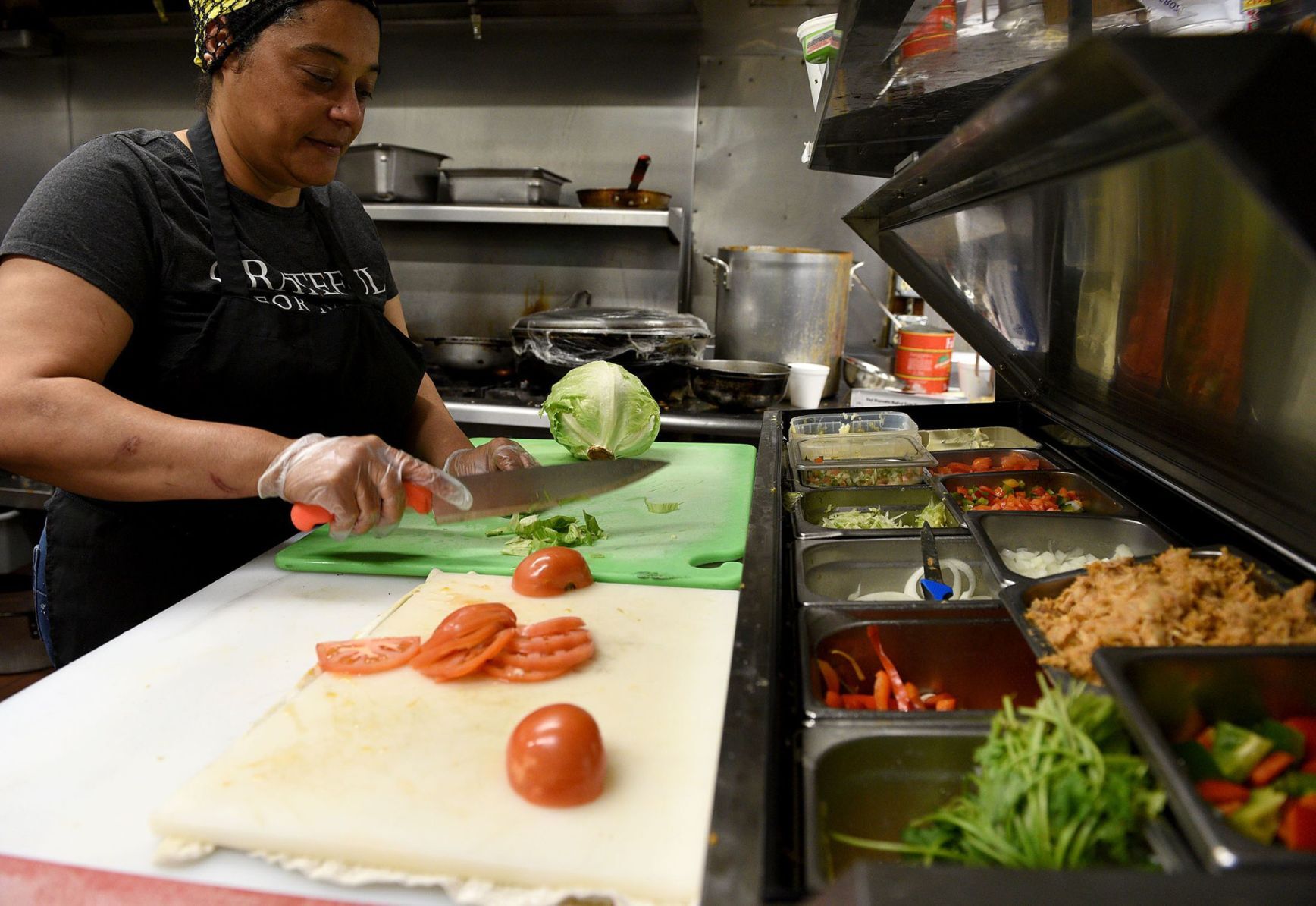 Eduarda Batista MacDonald chops vegetables